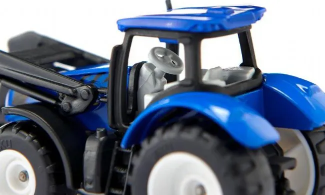 New Holland med pallegaffel og palle